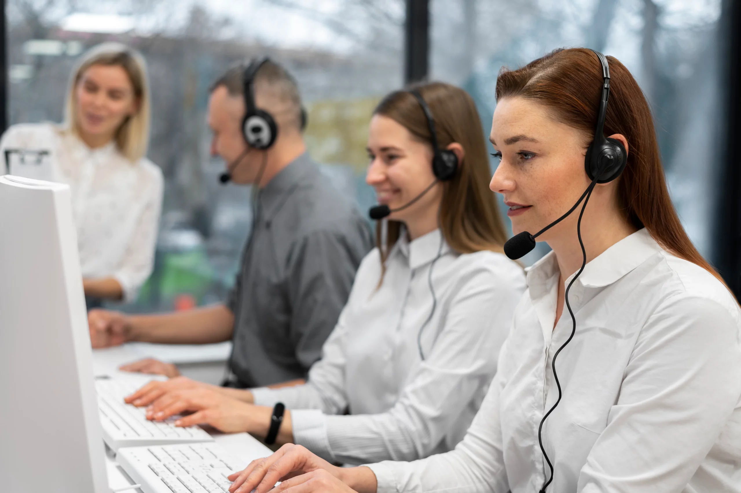 colleagues working together call center with headphones scaled